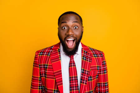 Closeup photo of amazed ecstatic dark skin guy good mood open mouth listen great news wear plaid red costume blazer white shirt isolated bright yellow color backgroundの写真素材