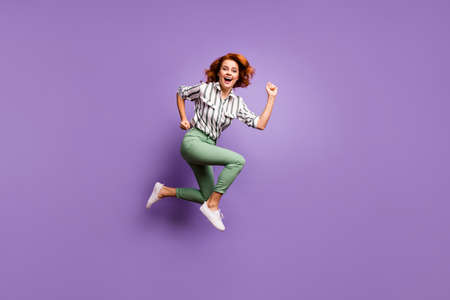 Full body profile side photo of cheerful candid woman jump run hurry after bargains enjoy rejoice free time wear formalwear style clothing isolated over violet color backgroundの写真素材