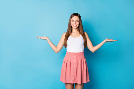 Portrait of positive cheerful girl promoter hold hand display advert promotion wear good look...