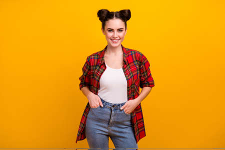 Photo of pretty brunette student lady teenager two cute funny buns good mood beaming teeth smile wear casual plaid shirt jeans isolated vibrant yellow color backgroundの写真素材