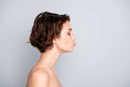 Profile side photo of romantic charming girl prepare for dreamy dating send air kiss copyspace isolated over gray color backgroundの写真素材
