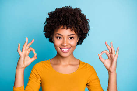 Portrait of positive cheerful afro american girl show okay symbol recommend her feedback about...