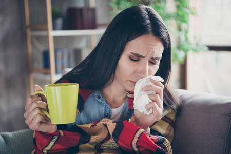 Photo of pretty suffering lady stay home quarantine covered checkered blanket hold paper napkin...