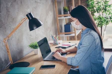 Profile side view portrait of her she nice attractive focused busy brunette girl professional copywriter designer financier using laptop working in modern loft industrial house apartment safe placeの写真素材