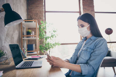 Profile side view portrait of her she nice attractive focused brunet girl employee copywriter designer using laptop device smm working in modern loft industrial house apartment safe placeの写真素材
