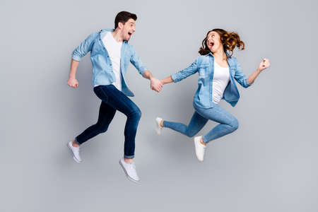 Full size photo of cheerful funky students spouses enjoy spring weekend rest jump hold hand run...