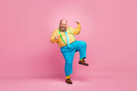 Full length body size view of his he nice funky crazy carefree positive glad bearded guy dancing having fun good mood rejoicing isolated over pink pastel color backgroundの写真素材