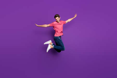 Full size profile photo of handsome attractive guy jump high up spread arms dance moves flight wear...