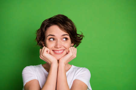 Closeup photo of funny attractive cheerful lady wavy bobbed hairdo look side empty space arms on...