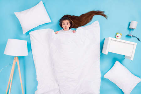 Full length high angle top above flat lay view photo of funny shocked lady lying floor pillow...
