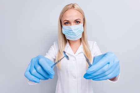Close-up portrait of her she nice attractive experienced girl medic wearing gauze mask using tools...