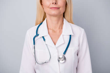 Cropped photo of qualified woman practitioner with stethoscope ready examine consult corona virus patient isolated over gray color backgroundの写真素材