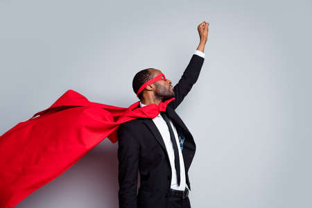 Profile side view portrait of attractive elegant guy rescuer wearing suit hero outfit career promotion motivation air wind blowing fly isolated over grey pastel color backgroundの写真素材