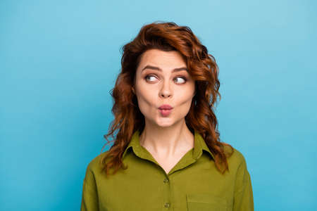 Portrait of lovely charming woman look copyspace want attract cute guy send 14-february air kiss wear trendy outfit isolated over blue color backgroundの写真素材