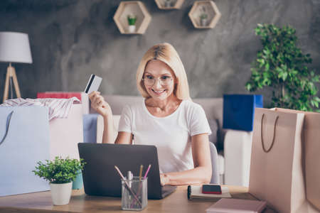 Portrait of her she nice attractive lovely pretty cheerful mature lady using laptop buying ordering...