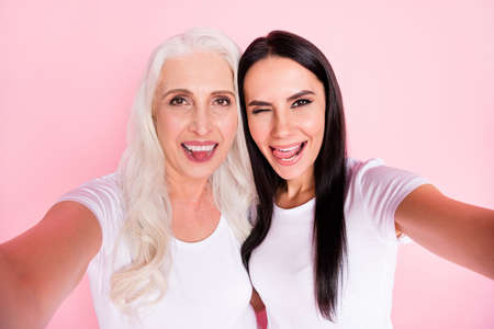 Closeup photo of cheerful aged mother young daughter ladies making selfies best friends funny...