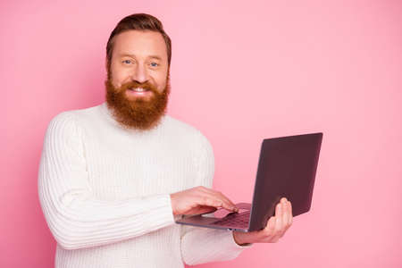 Portrait of positive cheerful guy work on his computer watch study learn video texting typing emails...