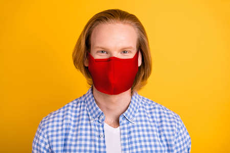 Close up photo of carefree cheerful nice cute freelancer stay home covid-19 quarantine wearing checkered shirt medical mask isolated over vivid color backgroundの写真素材