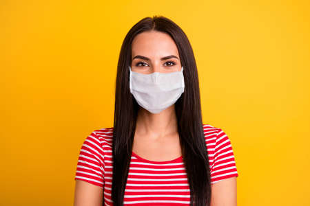 Close up photo of adorable youngster people stay home covid-19 quarantine wear medical mask fashionable clothing isolated yellow vibrant backgroundの写真素材