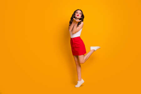 Full body profile photo of flirty lady holding arms near mouth sending air kisses handsome macho guy...