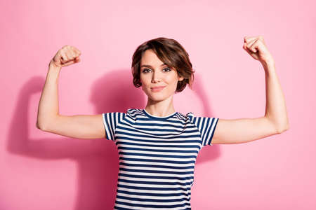 Portrait of successful strong girl bodybuilding trainer demonstrate her power muscles wear good look...
