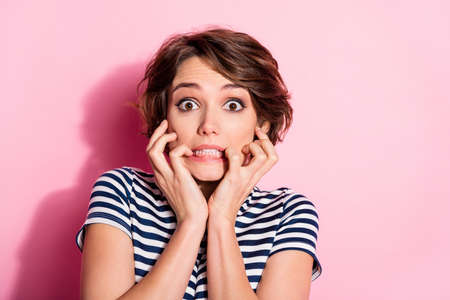 Closeup photo of attractive scared lady short hairdo eyes full of fear biting fingers failure watch...