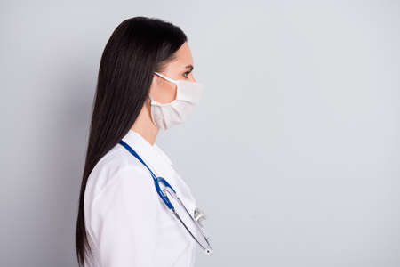 Close-up profile side view portrait of her she nice attractive confident skilled experienced girl consultant practitioner government clinic insurance isolated over grey pastel color backgroundの写真素材