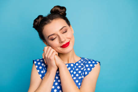 Closeup photo of pretty charming lady red pomade eyes closed hold hands near face overjoyed relaxed...
