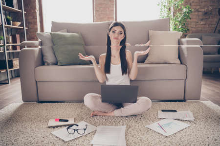 Full size photo of frustrated girl agent representative girl sit carpet legs crossed work laptop...