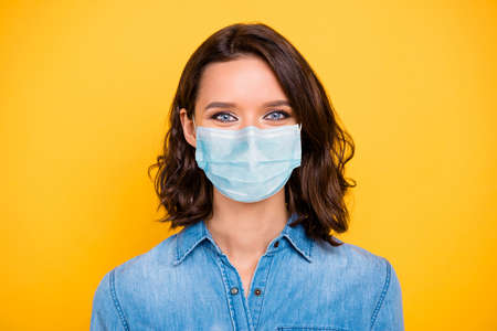 Close up photo of cheerful positive girl have free time enjoy summer vacation wear denim jeans outfit isolated over yellow color backgroundの写真素材