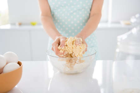 Cropped photo of housewife morning weekend preparing cookies for family children husband forming making mixing dough modern kitchen indoors casual clothingの写真素材