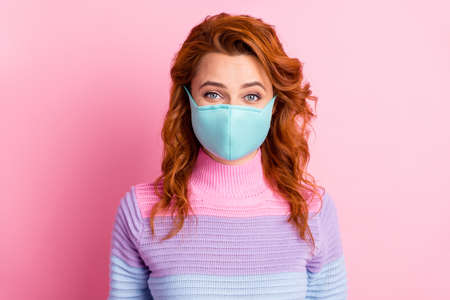 Portrait closeup photo of pretty lady keep social distance people contacting responsible citizen glad to be alive not giving up wear protect face mask sweater isolated pink color backgroundの写真素材