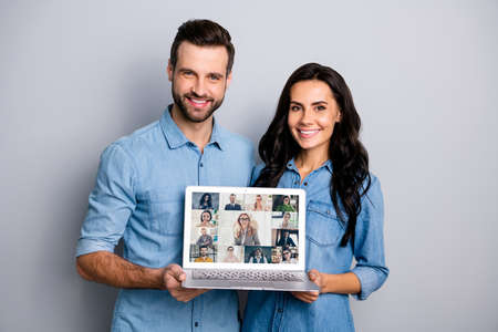 Lets have conversation distantly coronavirus concept. Photo collage of two professional successful human person holding showing netbook live broadcast of ceo members company isolated grey backgroundの写真素材