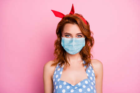 Close-up portrait of her she nice attractive charming pretty girl wearing gauze mask social distance sickness illness disease preventive measures isolated on pink pastel color backgroundの写真素材