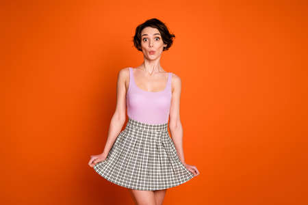 Portrait of astonished sweet girl lady have spring free time look incredible novelty impressed wear casual style clothes isolated over vibrant color backgroundの写真素材