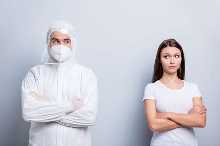 Photo of patient lady guy expert doc virology examination covid arms crossed look distrustful wear face mask hood uniform plastic facial protection eyes nose isolated grey color backgroundの写真素材