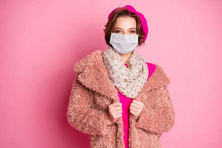 Portrait of her she attractive pretty fashionable lovely girl wearing gauze mask faux fur overcoat influenza prevention sars risk co2 environment isolated on pink pastel color backgroundの写真素材