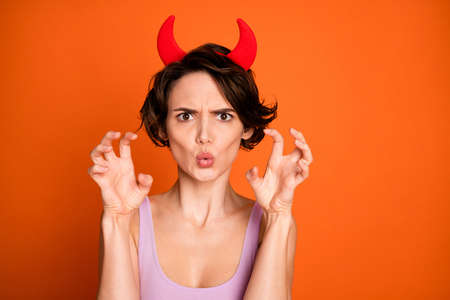 Scary ghost theme party character concept. Aggressive crazy teen girl hold fingers roar frighten her friends wear pink tank-top isolated over bright color backgroundの写真素材
