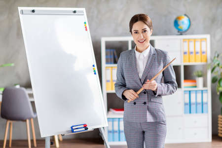 Photo of business teacher coach lady home education free online lesson hold stick stand white board...