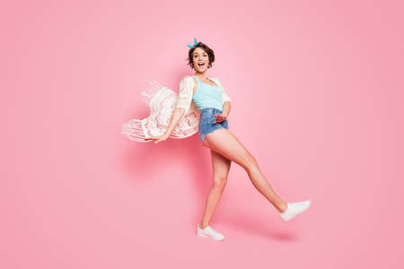 Full length body size of her she nice attractive lovely pretty cheerful cheery slim slender girl having fun walking strolling traveling isolated on pink pastel color backgroundの写真素材