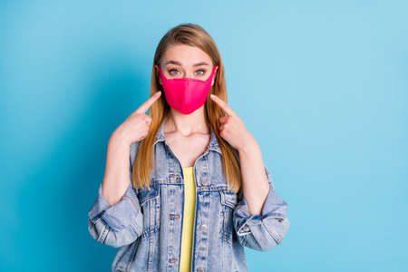 Photo of pretty lady social distancing not contact people direct fingers safety flu cold respirator showing best protection wear face mask denim blazer isolated blue color backgroundの写真素材