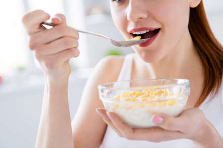Closeup cropped photo of pretty housewife lady sit morning kitchen have breakfast eat cereal corn...