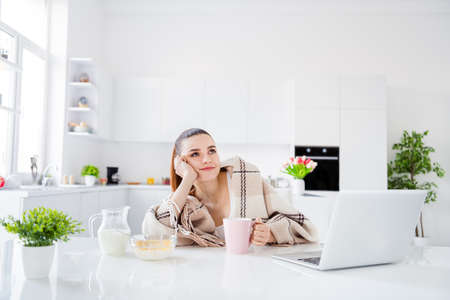 Photo of attractive homey housewife lady covered blanket morning lazy worker have breakfast drink coffee not interested working dreamy look up stay home quarantine time remote worker indoorsの写真素材