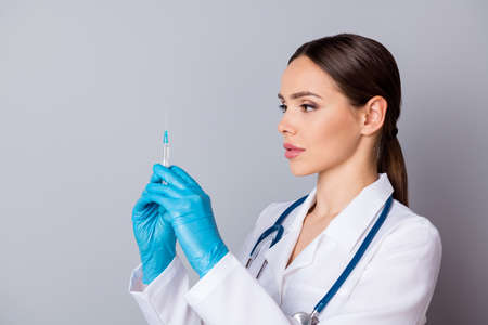 Closeup photo of professional doc serious nurse prepare syringe patient vaccination antibiotic wear...