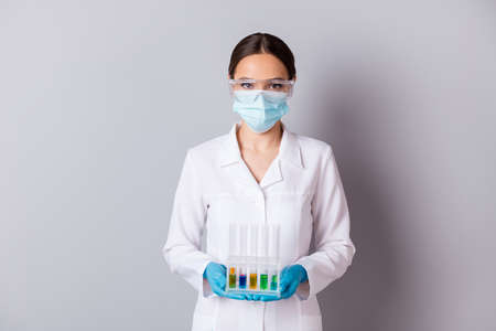 Photo of virologist doc lady experienced professional hold test flask tubes examining vaccine probes...