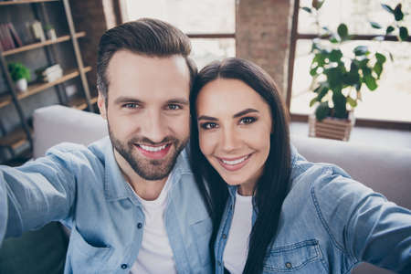 Close up photo of passionate caring loving married couple travel trip in hotel room make selfie...