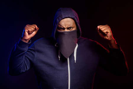 Photo of furious afro american guy raise fists support anti racism fight wear sweater jumper...
