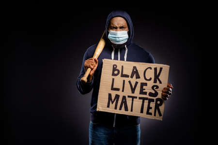 Photo of furious afro american guy hold cardboard banner ready fight african people equality rights...