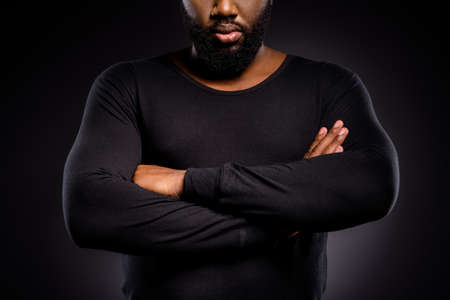 Cropped photo of serious afro american guy, cross hands ready fight for human equality isolated over black color backgroundの写真素材