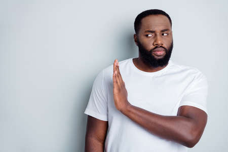 Photo of serious dark skin african guy community group member say no violence against black citizens lawlessness raise arm empty space care every human life isolated grey color backgroundの写真素材